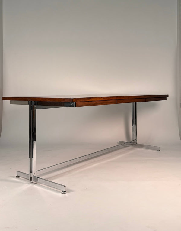Wooden table with metal legs on a plain background