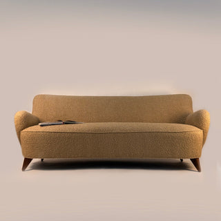 “Mid-century modern Barrel sofa by Vladimir Kagan, circa 1950s. Sculptural seating upholstered in warm sand-bouclé fabric, featuring a gently curved sweeping back and rounded arms that create an intimate and embracing silhouette.”