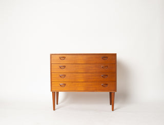 Wooden dresser with four drawers on a white background