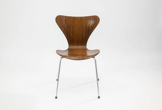 set of chairs in rosewood with metal legs on white background