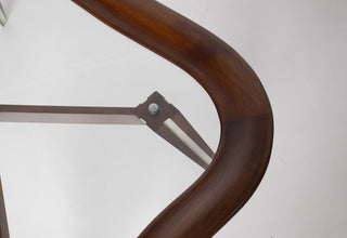 Filippo Chissotti biomorphic walnut and glass cocktail table Italy 1950s-60s, full front view showing sculptural continuous walnut frame and dramatically splayed paired legs with cream inlay stripe, Hobbs Modern San Diego