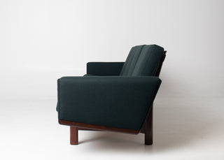 Close-up of the solid teak leg and lower frame detail on an authentic Hans Wegner GE-236 sofa by Getama.