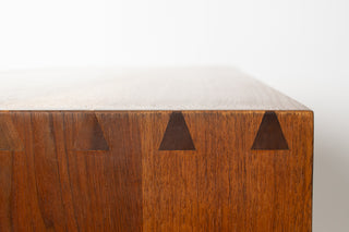 Wooden box with triangular cutouts on a white background