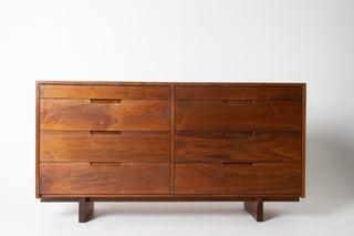 Wooden dresser with four drawers on a white background