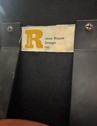 Jens Risom Design Inc. label on a black surface