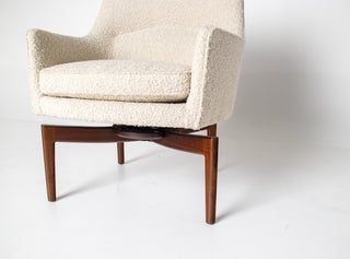 close up of boucle on swivel chair with walnut base