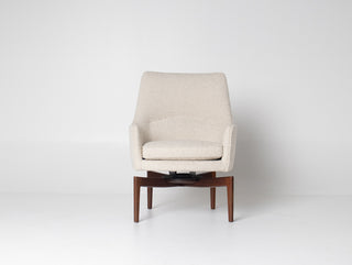 Beige swivel armchair with walnut legs on a white background