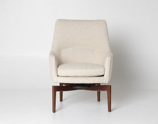 Beige armchair with wooden legs on a white background
