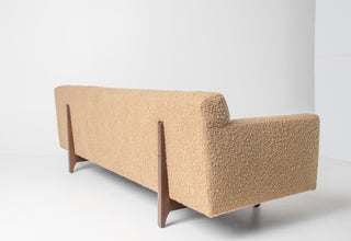 sofa in walnut and beige bouclè on whtie background