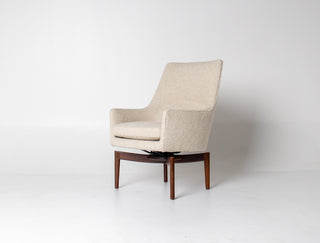 Beige armchair with wooden legs on a white background