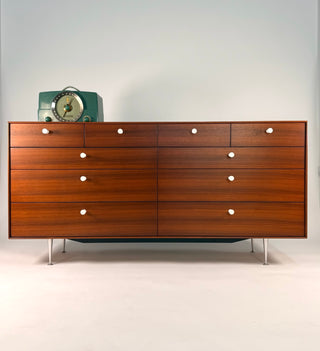 Wooden dresser with silver legs on a white background