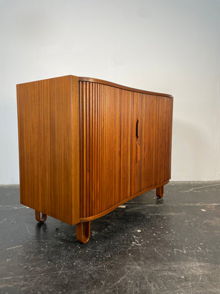 A vintage mahogany tamboured Mister Cabinet with hairpin legs and multiple drawers, showcasing a curved front design. Dunbar, Edward Wormley, Edward Wormley