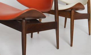 Side view of Seymour James Weiner for Kodawood clam shell chair highlighting sculptural silhouette and solid walnut construction.