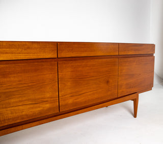 Sculptural curved lower stretcher detail showcasing the signature design language of Ib Kofod-Larsen.