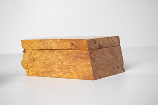 Michael Elkan Studio handcrafted burl wood box, three-quarter view showing swirling figured burl grain on lid and body with jagged natural edge