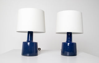 Two Gordon and Jane Martz for Marshall Studios hand-thrown cobalt blue ceramic table lamp bases with white drum shades, showing tapered cylindrical form