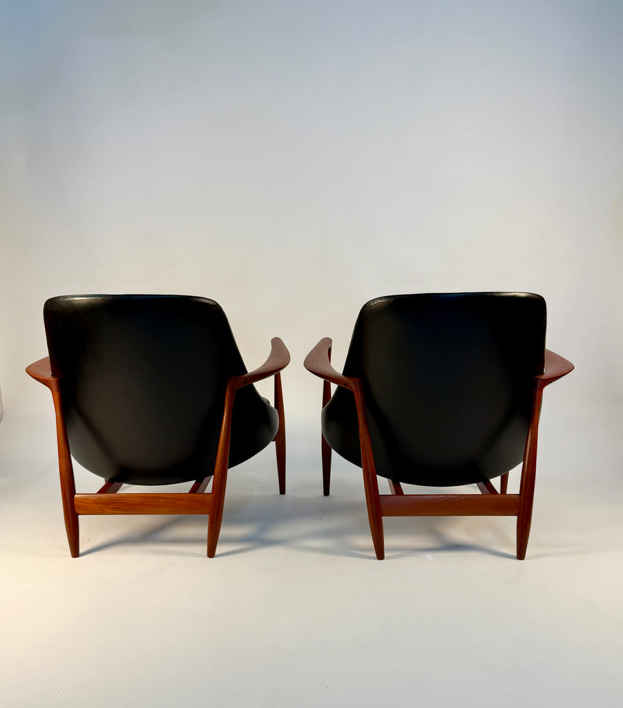 Back view of pair of black leather chairs designed by Ib Kofod Larsen.