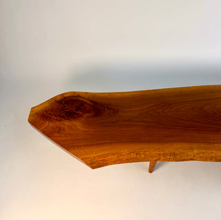 George Nakashima conoid coffee table showing the central rosewood butterfly joint. The natural live edges are visible 