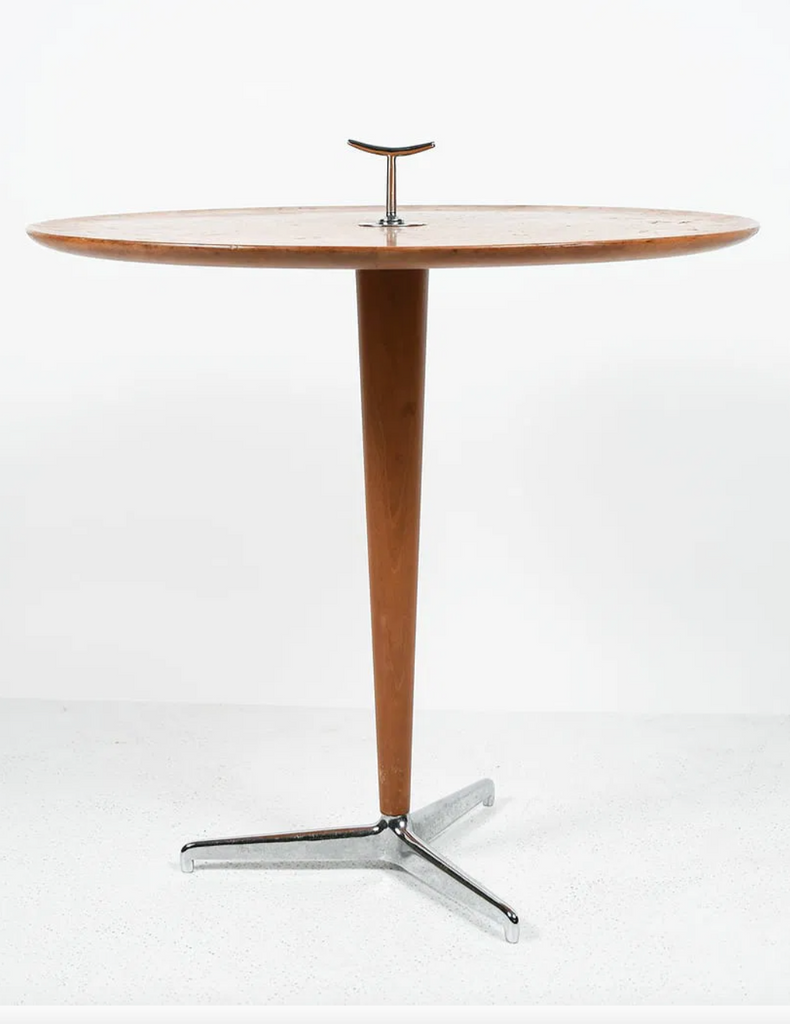Wooden table with a metal base on a white background